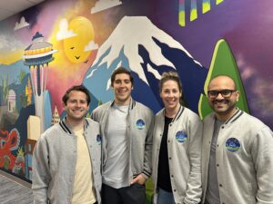 Photo of Zeno Power executives standing in front of muran in Seattle office