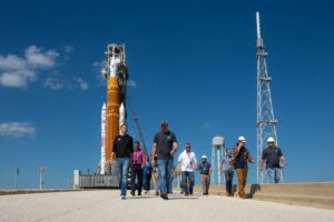 NASA Administrator Jared Isaacman and other personnel at LC-39B launch pad with SLS rocket in background