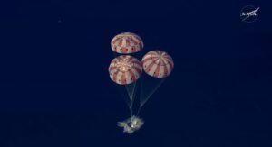 Orion splashdown as seen from above, with parachutes unfurled