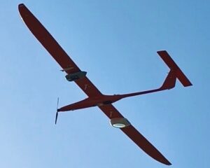 Fixed-wing drone in the air, seen from below