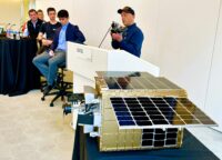 Show-and-tell panel with Paul Mikesell at podium and Otter Pup spacecraft in foreground