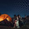 Campers looking at a smartphone with tent and streams of "Leo" logos in background
