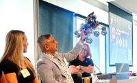 South Seattle College program director Joydeep Hazra holds up a prototype Mars rover. (GeekWire Photo / Alan Boyle)