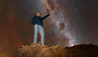 Philip Johnston pointing at Alpha Centauri in the night sky