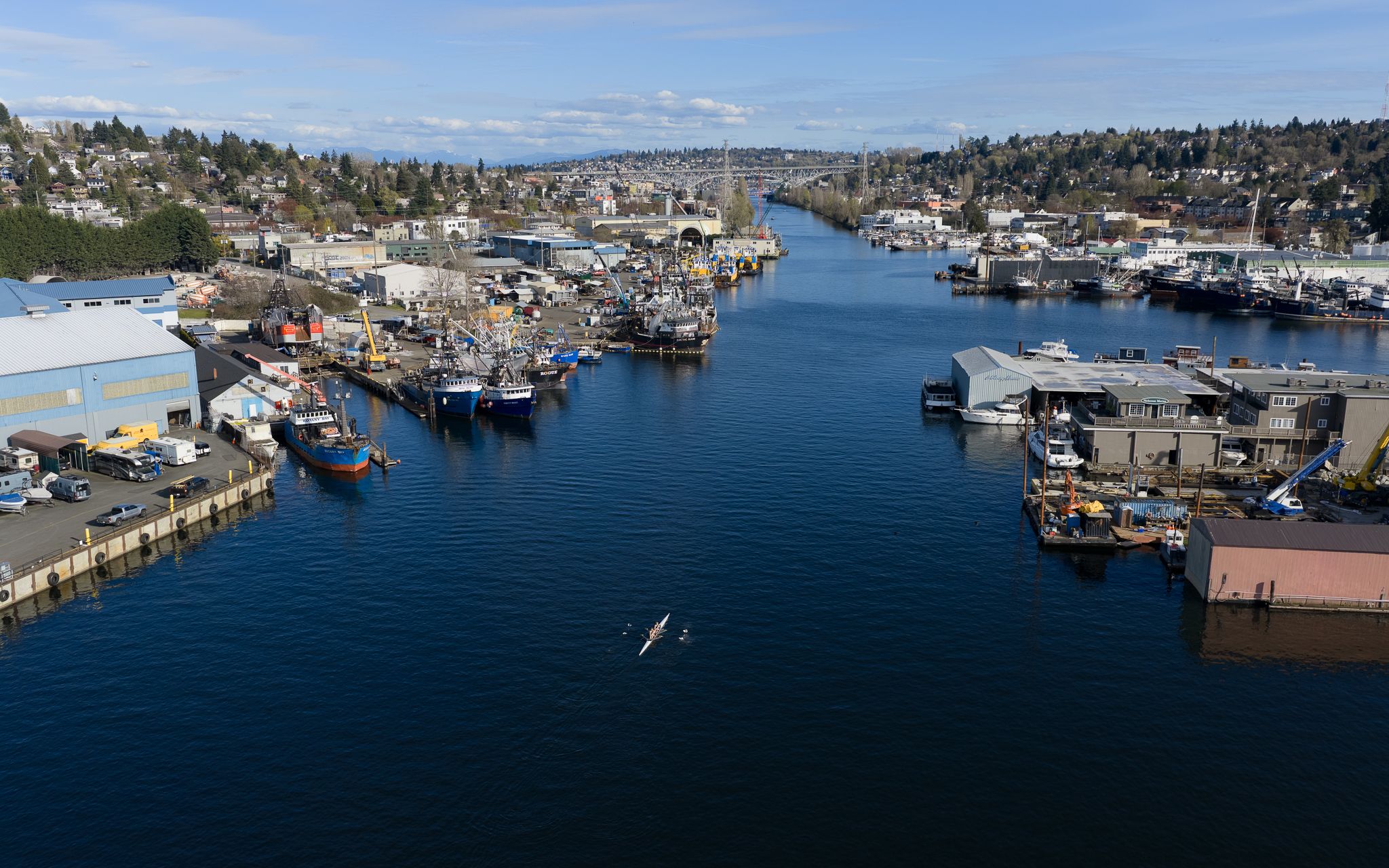 The Lake Washington Ship Canal, the working waterway connecting Lake Union to Puget Sound, where shipyards, fishing boats and houseboats share the shoreline with the region’s new wave of tech startups. (GeekWire Photo / Kevin Lisota)