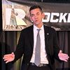 NASA Administrator Jared Isaacman on stage with Rocketdyne logo in background