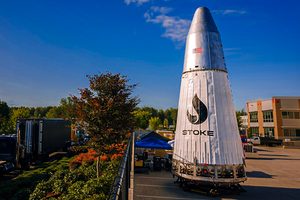 Stoke Space's Nova second stage sitting in open area surrounded by buildings and trees