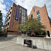 The Paul G. Allen Center, a brick building with a banner for the Paul G. Allen School of Computer Science & Engineering, on the University of Washington campus.