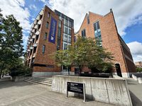 The Paul G. Allen Center, a brick building with a banner for the Paul G. Allen School of Computer Science & Engineering, on the University of Washington campus.